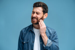 man suffering acute toothache